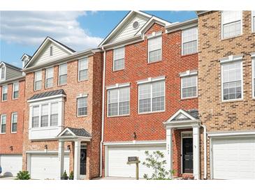Beautiful brick townhomes with attached garages and well-maintained landscaping at 3505 Chattahoochee Summit Se Ln # 25, Atlanta, GA 30339