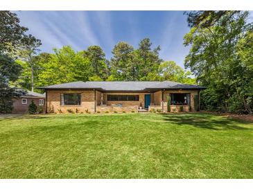 Charming brick home with a well-manicured lawn and mature trees offering great curb appeal at 639 W Ponce De Leon Ave, Decatur, GA 30030