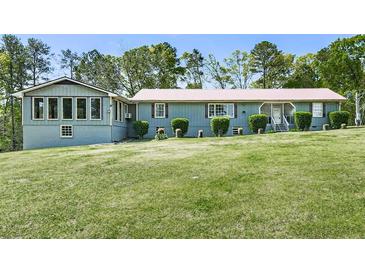 Inviting single-story home with well-manicured lawn and mature trees at 72 Hazelwood Nw Rd, Cartersville, GA 30121