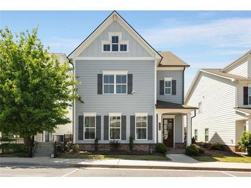 Charming two-story home featuring light blue siding and dark shutters against the backdrop of a clear blue sky at 2316 Echelon Ln, Smyrna, GA 30080