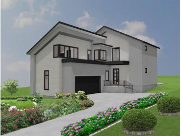 Two-story home with a modern design, attached garage, and landscaped front yard and driveway at 246 Garland Ave, Decatur, GA 30030