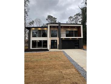 Modern two-story home featuring a balcony and large windows at 1921 Herbert Dr, Tucker, GA 30084