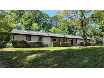 Inviting single-story home with a well-manicured lawn and mature landscaping at 3451 San Antonio Dr, Snellville, GA 30039