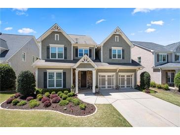 Charming two-story home with a well-manicured lawn and a two-car garage, creating a welcoming curb appeal at 3883 Wakefield Hall Se Sq, Smyrna, GA 30080