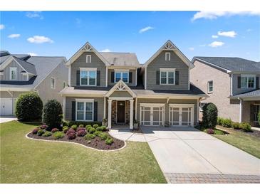 Charming two-story home with a manicured lawn and a two-car garage at 3883 Wakefield Hall Se Sq, Smyrna, GA 30080