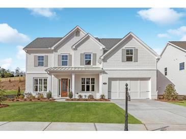 Charming two-story home with white brick and manicured lawn, complete with a two-car garage at 3345 Hillshire Dr, Cumming, GA 30028