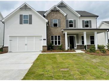 Charming two-story home featuring a brick facade, white siding, and a well-manicured lawn at 3355 Hillshire Dr, Cumming, GA 30028