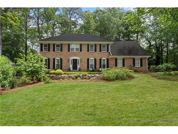 Traditional brick home with a well-maintained lawn and landscaping, creating a classic curb appeal at 4979 Shadow Glen Ct, Dunwoody, GA 30338