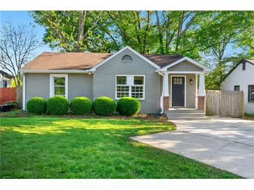 Charming one-story home with a well-manicured lawn and inviting front porch at 1258 Lyle Ave, Atlanta, GA 30344