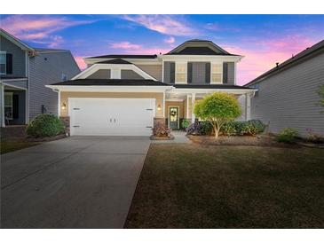 Inviting two-story home featuring a manicured lawn and a convenient two-car garage at 357 Ridgewood Trl, Canton, GA 30115