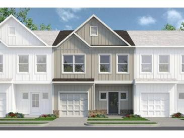 Charming townhome featuring a modern exterior with a one car garage at 99 Alameda St # 14, Loganville, GA 30052