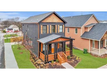 Beautiful two-story home with a inviting front porch, wood accents and well-maintained lawn at 701 Smith St, Atlanta, GA 30310
