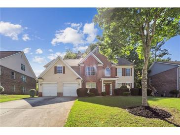 Charming two-story home with a well-manicured lawn, two-car garage, and beautiful landscaping at 1520 Ethans Way, Mcdonough, GA 30252