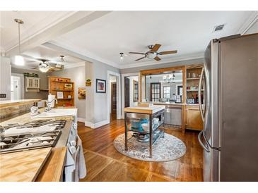 Bright kitchen with an island, stainless steel appliances, and hardwood floors at 698 Bellemeade Nw Ave, Atlanta, GA 30318