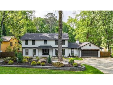 Charming two-story home with brick accents, lush landscaping, and a well-manicured lawn creating inviting curb appeal at 3270 Brookview Dr, Marietta, GA 30068