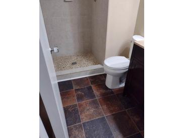 Tile shower and multi-color floor in this bathroom at 3088 Balearic Dr, Marietta, GA 30067