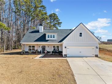 Charming home featuring a modern design with a welcoming front porch and well-manicured landscaping at 104 Federal Path, Temple, GA 30179