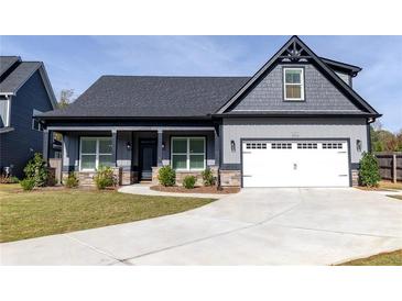 Charming home featuring gray siding, stone accents, and a well-manicured lawn at 2710 Sandy Irwin Sw Ct, Marietta, GA 30064