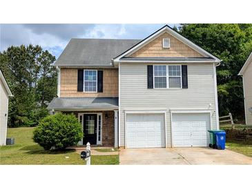 Charming two-story home with a two-car garage and well-manicured lawn, creating a welcoming curb appeal at 3104 Leyland Ct, Decatur, GA 30034
