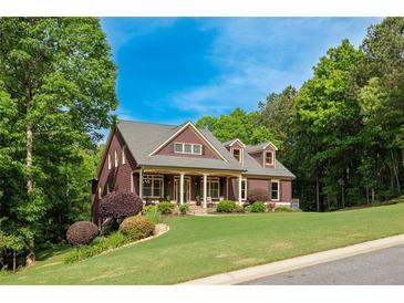 Charming two-story home featuring a landscaped yard and a welcoming front porch at 313 Red Fox Dr, Canton, GA 30114