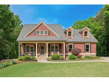 Inviting two-story home featuring a covered front porch, landscaped yard and a symmetrical facade at 313 Red Fox Dr, Canton, GA 30114