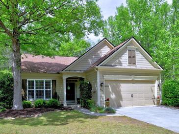 Charming one-story home with well-maintained lawn, inviting curb appeal and attached two-car garage at 111 Churchcliff Dr, Woodstock, GA 30188