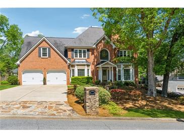 Beautiful two-story brick home with a two-car garage and meticulously landscaped front yard at 579 Delphinium Nw Blvd, Acworth, GA 30102