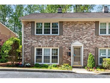 Charming brick townhouse with inviting curb appeal and mature landscaping at 2495 Northlake Ne Ct, Atlanta, GA 30345