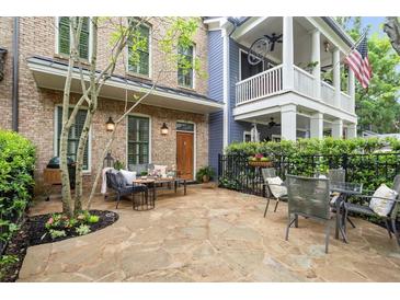 Charming stone patio with outdoor seating, perfect for entertaining or relaxing at 719 Hammond Dr, Woodstock, GA 30188