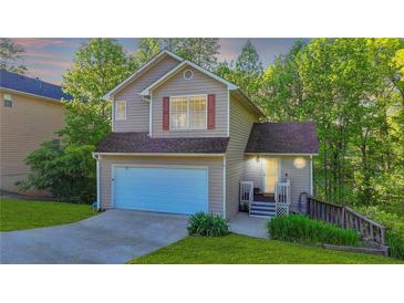 Charming two-story home with a well-manicured lawn, attached garage, and inviting front porch at 986 Franklin Ridge Ct, Sugar Hill, GA 30518