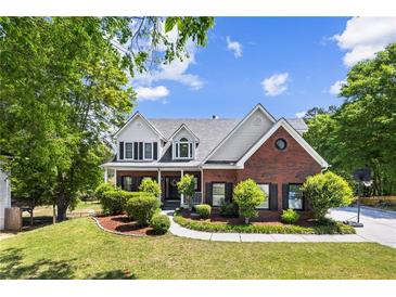 Charming brick two-story home with a landscaped front yard and welcoming curb appeal at 1156 Cotton Gin Ct, Lawrenceville, GA 30045