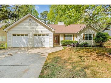 Charming single-Gathering home featuring a two-car garage and well-maintained front yard landscaping at 6095 Wayfarer Dr, Villa Rica, GA 30180