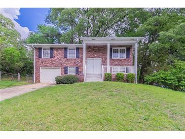 Charming two-story brick home with a well-manicured lawn and welcoming front porch at 5340 The Savoy St, Atlanta, GA 30349