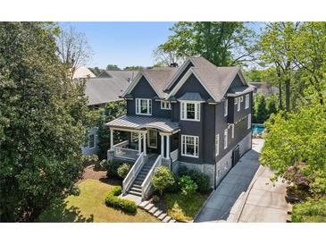 Charming two-story home with a well-manicured lawn, stone accents, and a private driveway at 331 Peachtree Ne Ave, Atlanta, GA 30305