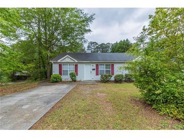 Charming single-story home featuring a well-maintained front yard and classic curb appeal with red shutters at 8051 Trinity Park Dr, Riverdale, GA 30296