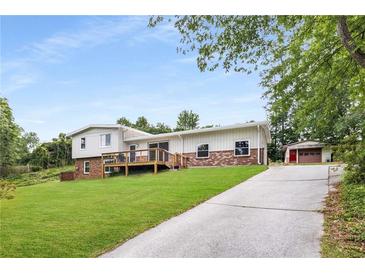 Charming two-story home featuring a spacious yard, detached garage, and wooden deck at 1619 Folkstone Ne Rd, Brookhaven, GA 30329