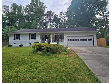 Charming home with a well-manicured lawn, covered porch, and an attached garage at 2799 Mockingbird Cir, Duluth, GA 30096