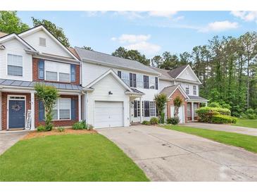 Inviting two-story townhome featuring a well-maintained lawn and attached one car garage at 3022 Kentmere Dr, Cumming, GA 30040