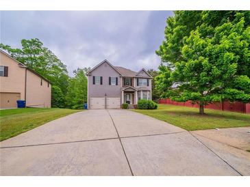 Charming two-story home featuring a two-car garage and a well-manicured front lawn at 535 Pierpoint Dr, Atlanta, GA 30331