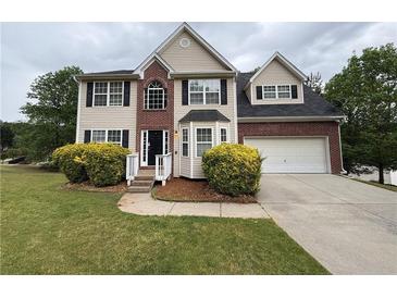 Charming two-story home with manicured lawn and attached two-car garage at 1822 Millwood Park Ct, Buford, GA 30518