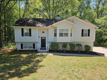 Charming home with a well-maintained lawn, trimmed shrubs, and a inviting front entrance at 71 Streamview Trl, Douglasville, GA 30134