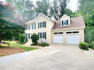 Charming two-story home with a two car garage, green shutters, and beautifully landscaped front yard at 2980 Milford Sw Trl, Marietta, GA 30008