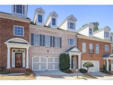 Charming brick townhomes with well-manicured landscaping and inviting front entrances on a sunny day at 10462 Bent Tree Vw, Duluth, GA 30097