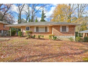 Charming brick home with covered porch and well-maintained landscaping in a peaceful, tree-lined neighborhood at 1815 Windsor Sw Dr, Atlanta, GA 30311