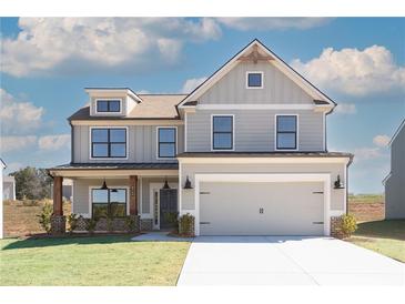Two-story home featuring gray siding, a two-car garage, and a well-manicured lawn at 4140 Chapel Hill Reserve, Douglasville, GA 30135