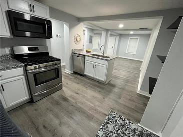 Modern kitchen with stainless steel appliances, granite countertops, and an open layout perfect for entertaining at 2040 Penelope Nw St, Atlanta, GA 30314