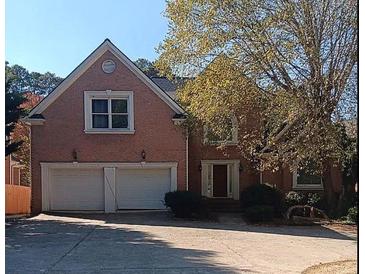 Charming two-story brick home with a two-car garage and well-manicured landscaping at 4746 Chamblee Dunwoody Rd, Atlanta, GA 30338