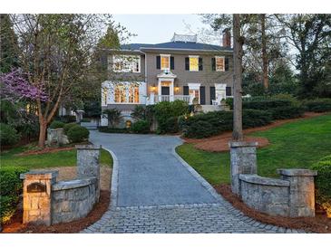 Stunning two-story home with a well-manicured lawn, beautiful trees, and a charming driveway at 3 Demorest Ne Ave, Atlanta, GA 30305
