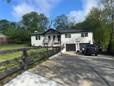 Charming home with a two-car garage, a spacious driveway, and black trim at 369 Arnold Mill Rd, Woodstock, GA 30188