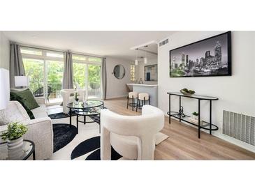 Bright living room with modern decor, stylish furniture, and large windows offering ample natural light at 120 Alden Nw Ave # D2, Atlanta, GA 30309